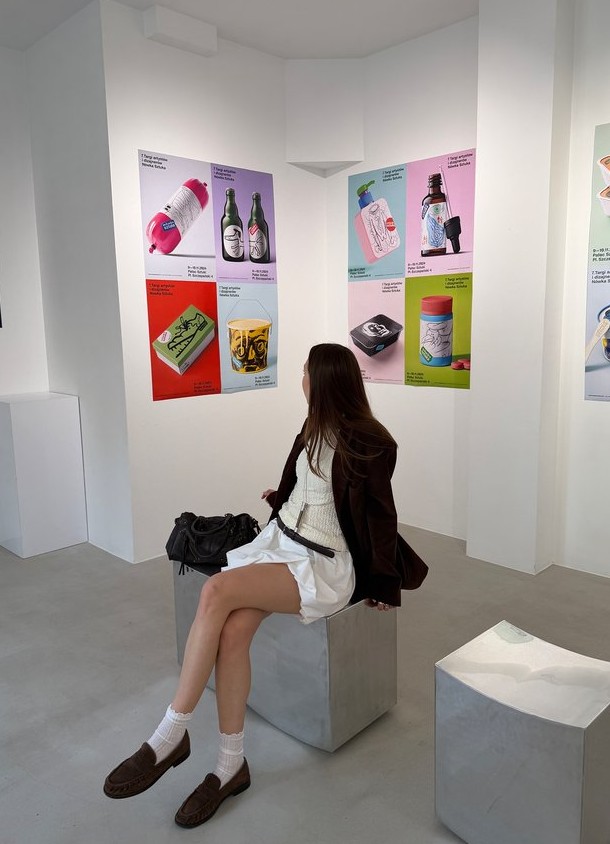 Sitting in a gallery surrounded by colorful prints